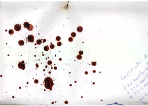 Experimental blood splatter pattern on white background with writing in the corner describing the experiment for court purposes